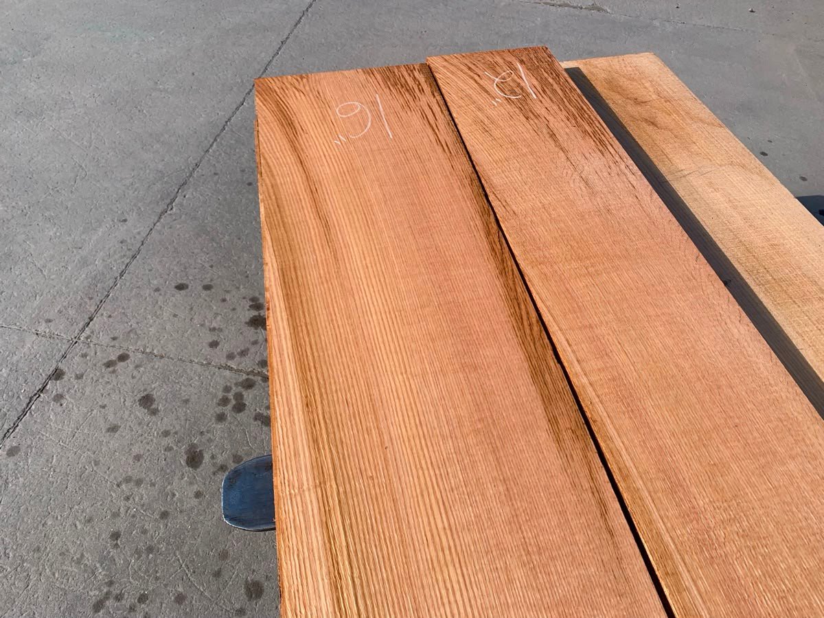 Red oak lumber boards showing warm reddish tones and distinctive grain